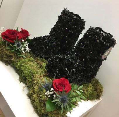 3D Army Boots funeral tribute styled as black military boots with ribbon laces, gold button detail, army badge and red, white and blue floral focal, 17 x 17 inch base, 18 inch height, customisable flower colours.