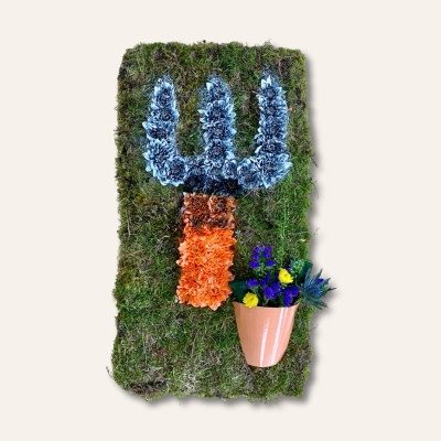 Garden fork funeral tribute with moss base and sprayed chrysanthemums, this design can also be created in a garden spade shape. 