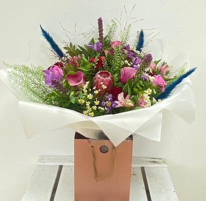 Ruby Jewel bouquet with roses, calla lily, clematis, liatris and pampas grass in jewel-toned shades.