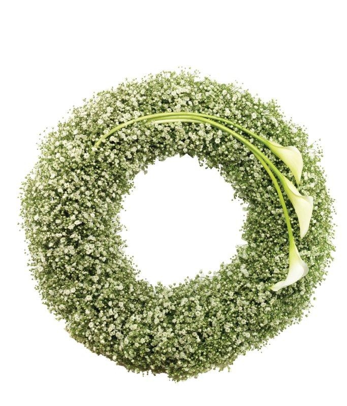 White massed gypsophila funeral wreath with a luxurious white calla lily focal.