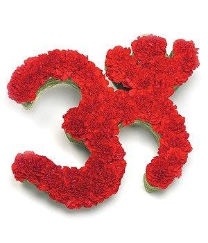 Aum symbol funeral tribute with red carnation base and leaf edge.