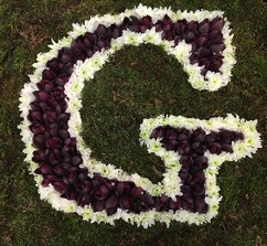 Letter-shaped funeral tribute on a 24