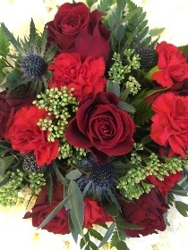 British-themed teapot-shaped funeral tribute made with white chrysanthemum base and red and blue accent flowers, measuring approximately 58cm x 61cm.
