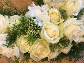 Heart-shaped funeral tribute with white luxury flowers and foliage, created as a tribute to Manchester.