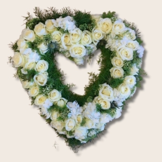 Heart-shaped funeral tribute with white luxury flowers and foliage, created as a tribute to Manchester.