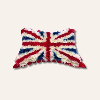 Union Jack pillow funeral tribute made with white chrysanthemums sprayed red, white, and blue.