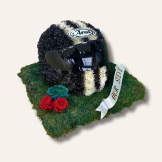 3D motorbike helmet-shaped funeral tribute made from flowers, with optional real or laminated visor, custom colours, and personal detailing such as roses or ribbon name tag.