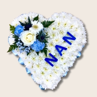 Heart-shaped funeral tribute with laminated wording, white chrysanthemums, delicate ribbon edge, and matching focal. Customisable colour options available.