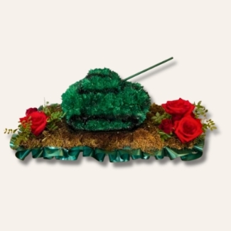 3D army tank-shaped funeral tribute on a 2ft x 2ft moss base, featuring sprayed chrysanthemum, cannon detail and rolling wheel tracks, with tank measuring around 10