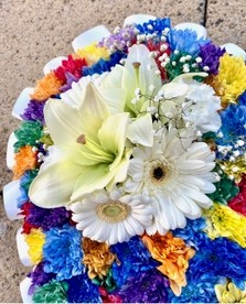 Intricate heart-shaped funeral tribute with sprayed chrysanthemum, white ribbon edge, and white focal flowers.