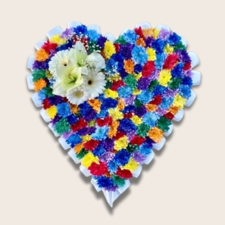 Intricate heart-shaped funeral tribute with sprayed chrysanthemum, white ribbon edge, and white focal flowers.