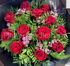 Dozen luxury red roses with fresh-scented wax flowers, accented with diamanté and complementary foliage, wrapped in luxury cellophane and matching gift bag, hand-tied in water.