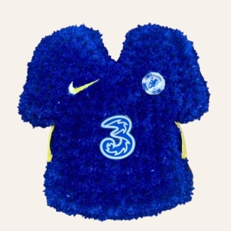 Chelsea FC shirt funeral tribute with chrysanthemum base, pipework accents and waterproof printed crests, 21 x 21 inches, available in retro and modern shirt versions.