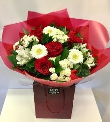 Red and white romantic flower bouquet, hand-tied and gift wrapped.