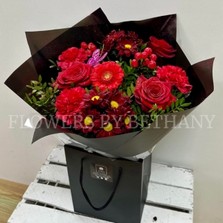 Sparkling red Valentine’s bouquet with diamanté detail and butterfly accent.