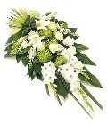 Modern flat spray with gladioli, roses, chrysanthemums, and stocks, complemented by foliage.